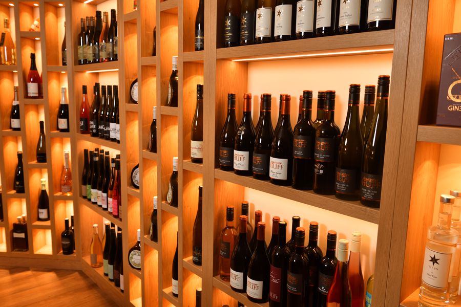 Ausstellung unterschiedlicher Getränkeflaschen im Regal.